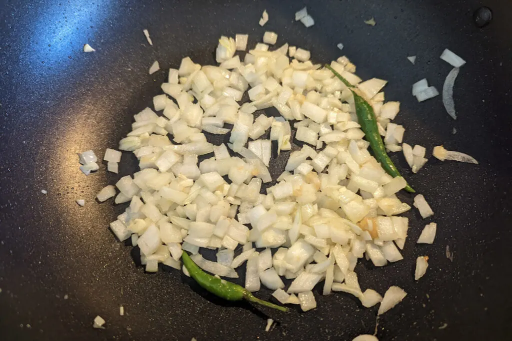 Onions and chiles frying in oil.