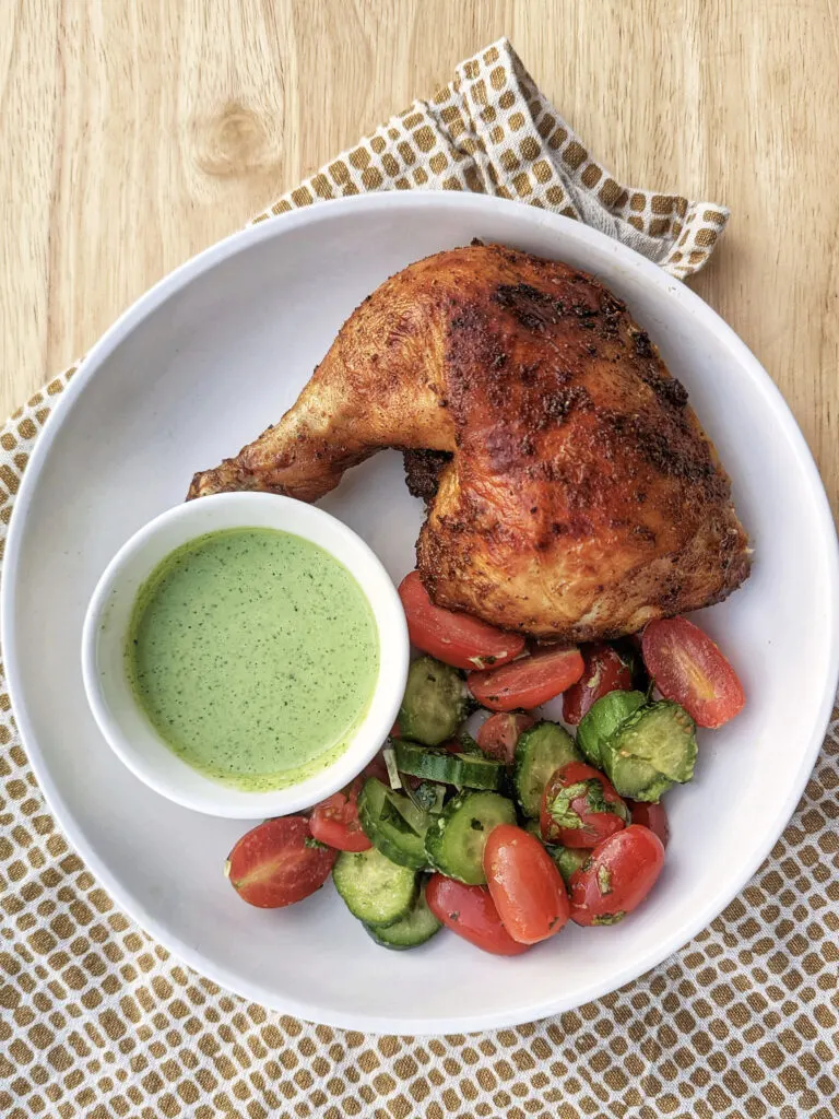 A single serving of our Peruvian roasted chicken served with serrano crema and salad.