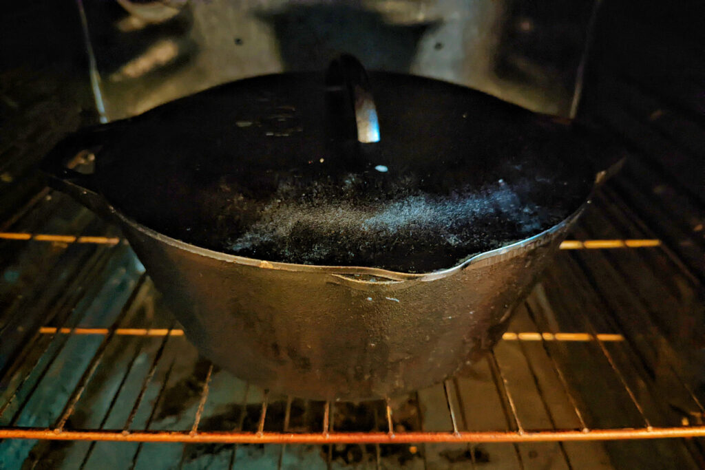 A dutch oven of Rindsgulasch in the oven.
