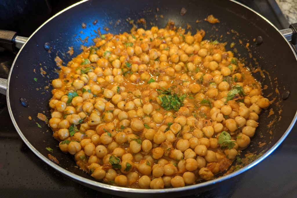 Authentic Chana Masala simmering in the pan.