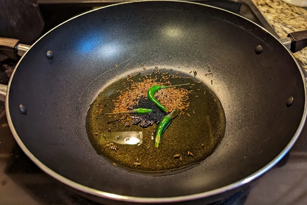 Cumin and chilies roasting in a skillet.
