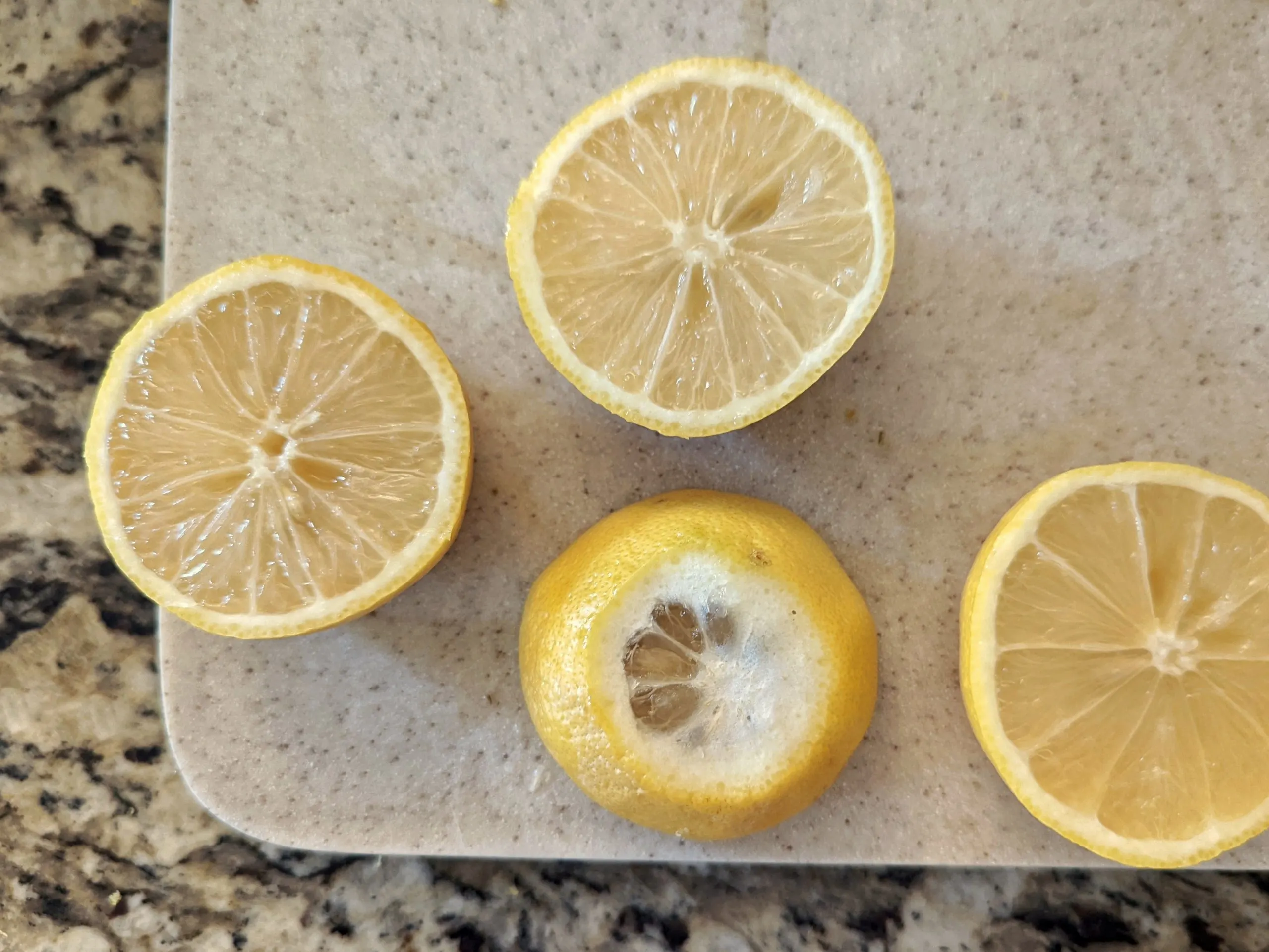 Cut the ends of the lemon off and then cut it in half.