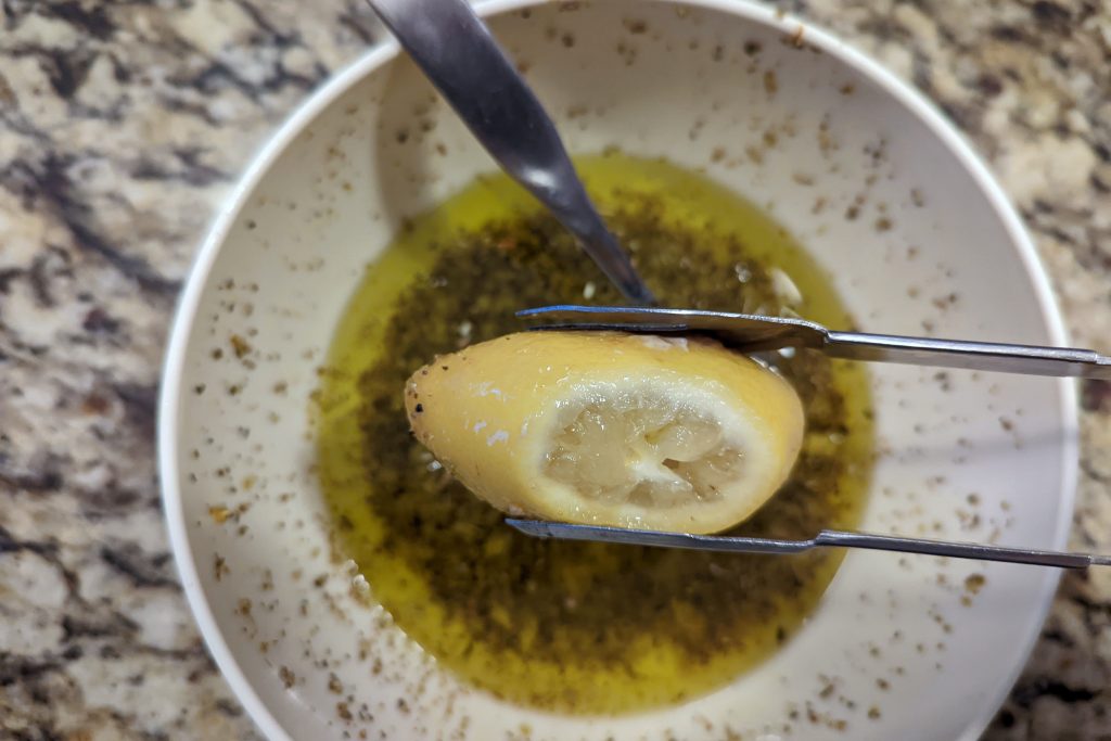 cooked lemons added to salmoriglio sauce