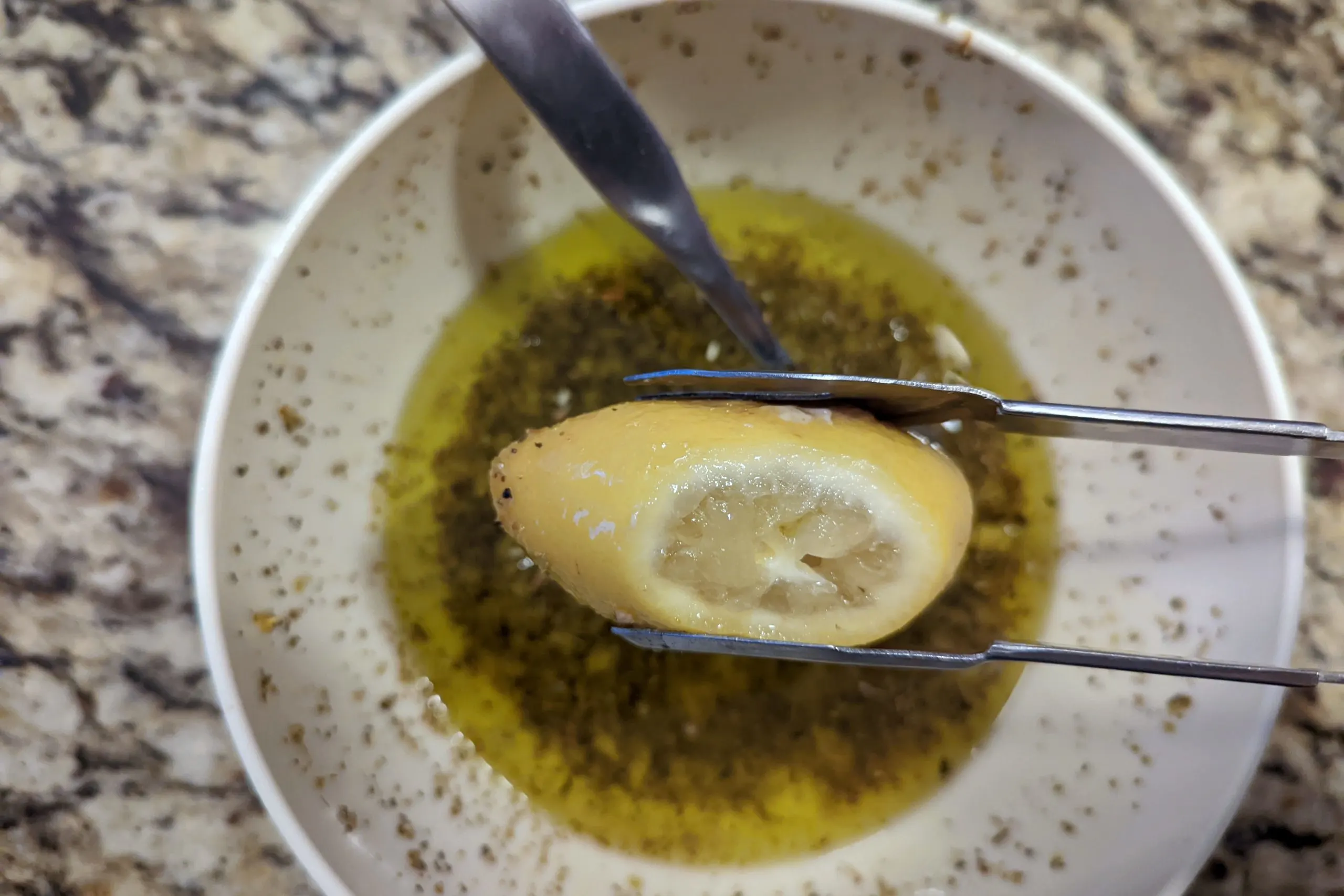 Remove the cooked lemons and squeeze it into the salmoriglio sauce.