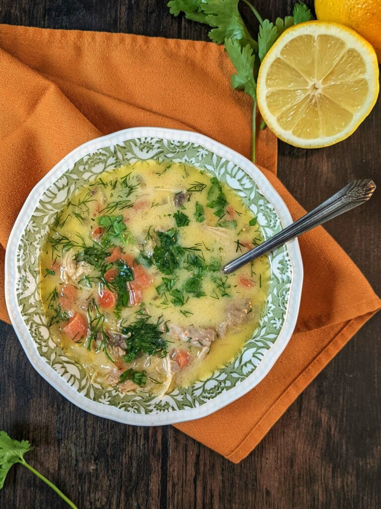 A single serving of homemade chicken soup garnished with cilantro..