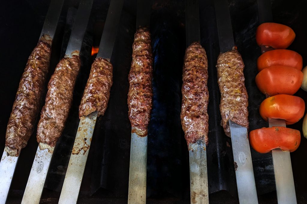 Form the meat onto the skewer and place them on the grill.