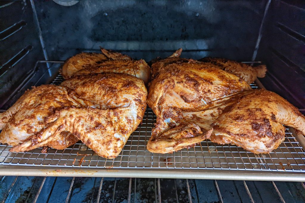 Peruvian roasted chicken baking in oven