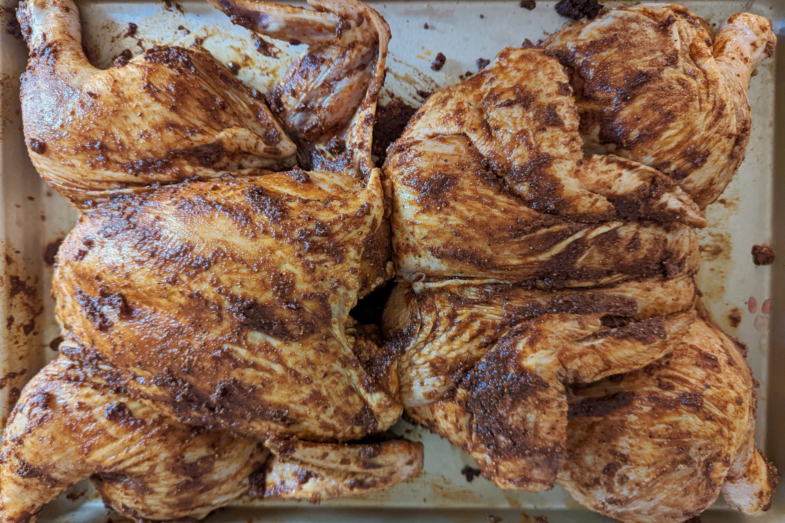 Peruvian roasted chicken covered in marinade and spices.