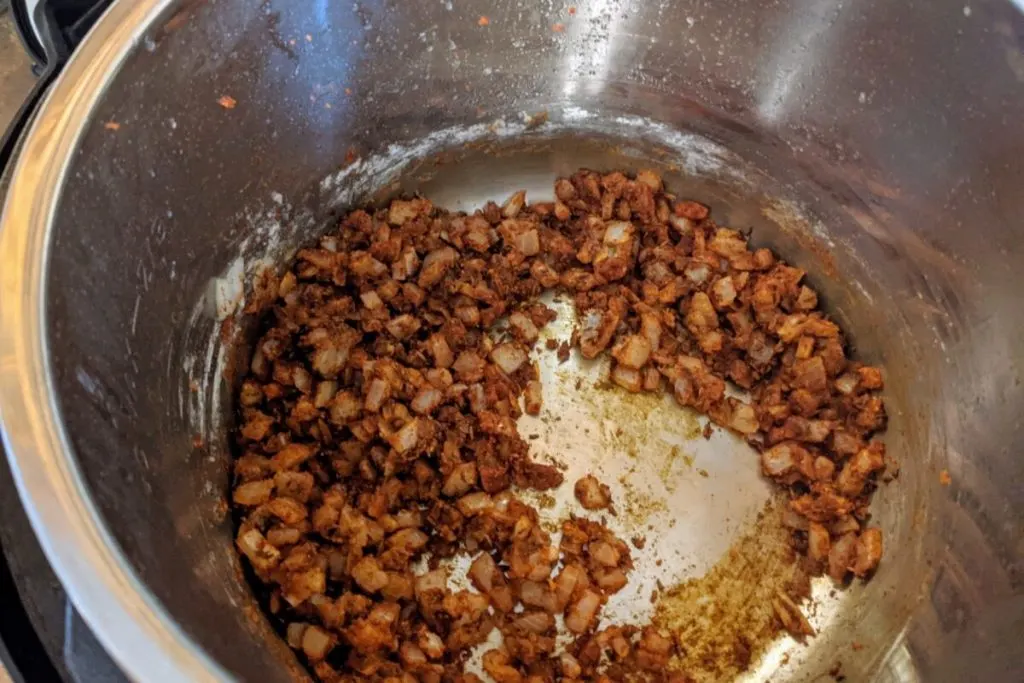 Spices added to the cooking onions in the Instant Pot.