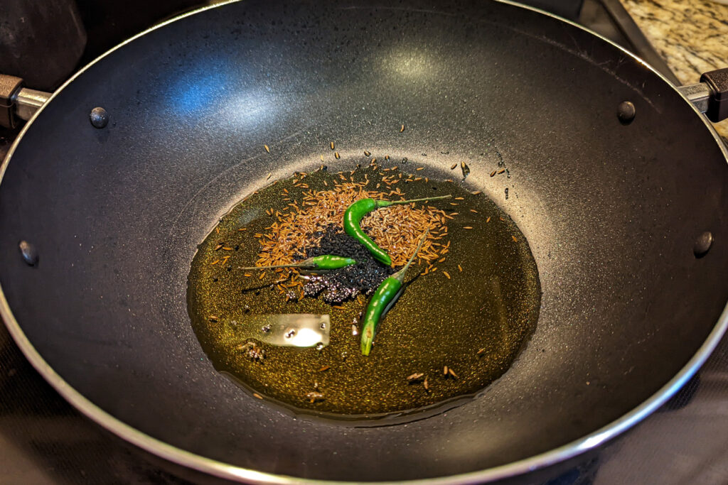 Cumin and chiles in a skillet.