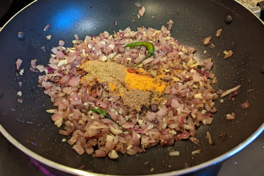 Spices and onions cooking pan.