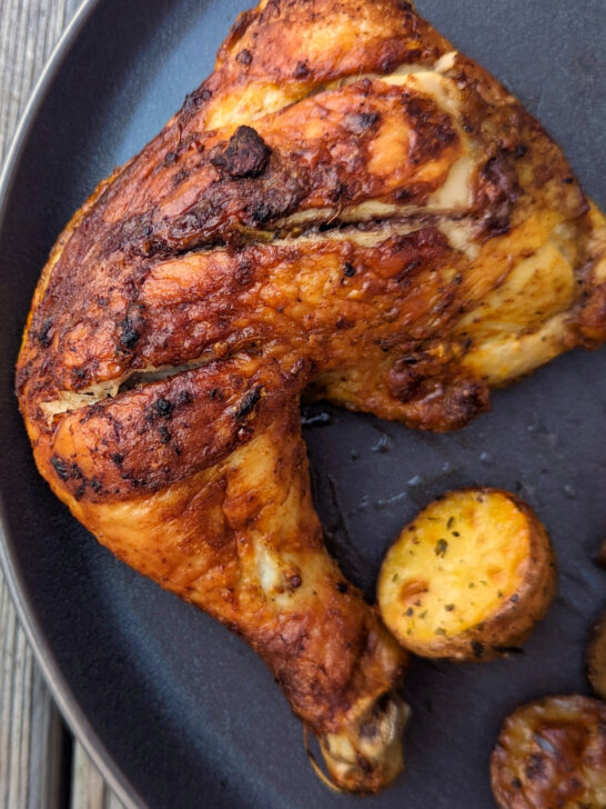Baked tandoori chicken on a plate.