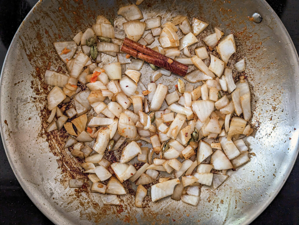 Onions slow cook to create flavor for the butter chicken curry..