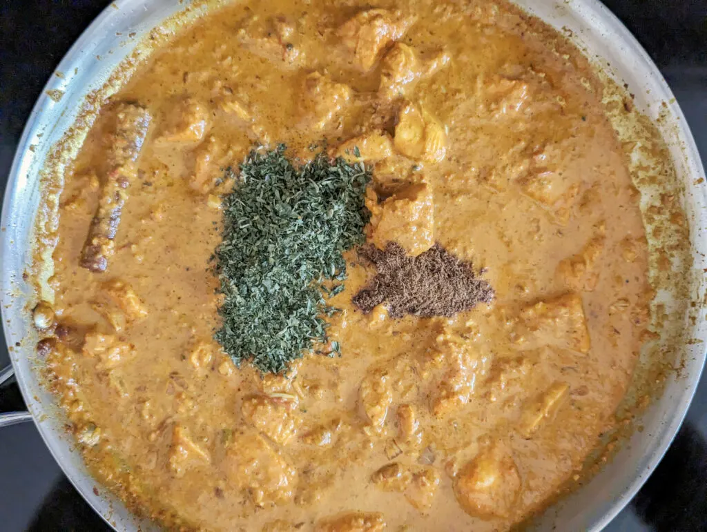 Finish the butter chicken with garam masala and fenugreek leaves.