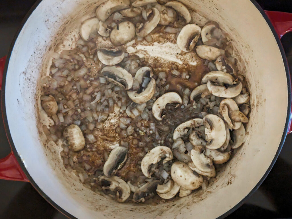 Add mushrooms, onion, and garlic to the Dutch oven.
