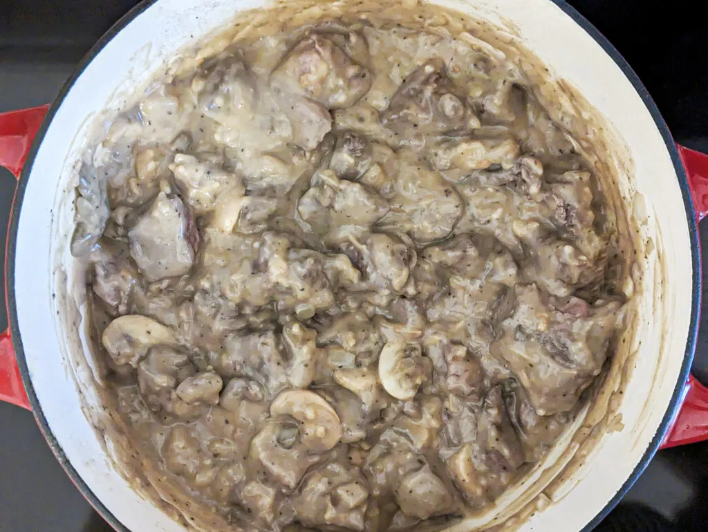 Beef and cream of mushroom added to the dutch oven.