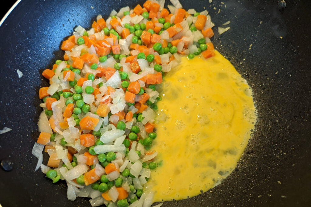 Eggs stir fried into the cooking vegetables.