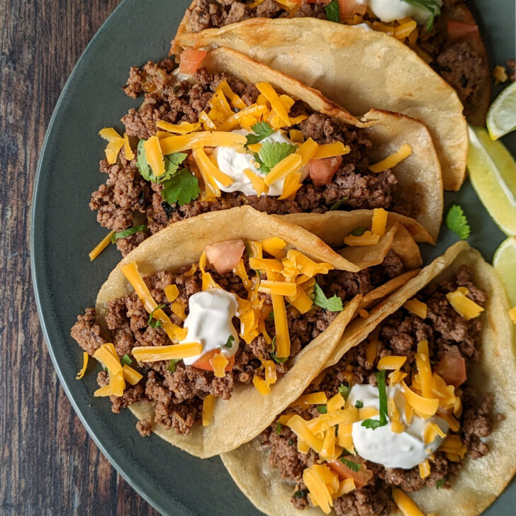 Homemade tacos with ground beef on a plate.