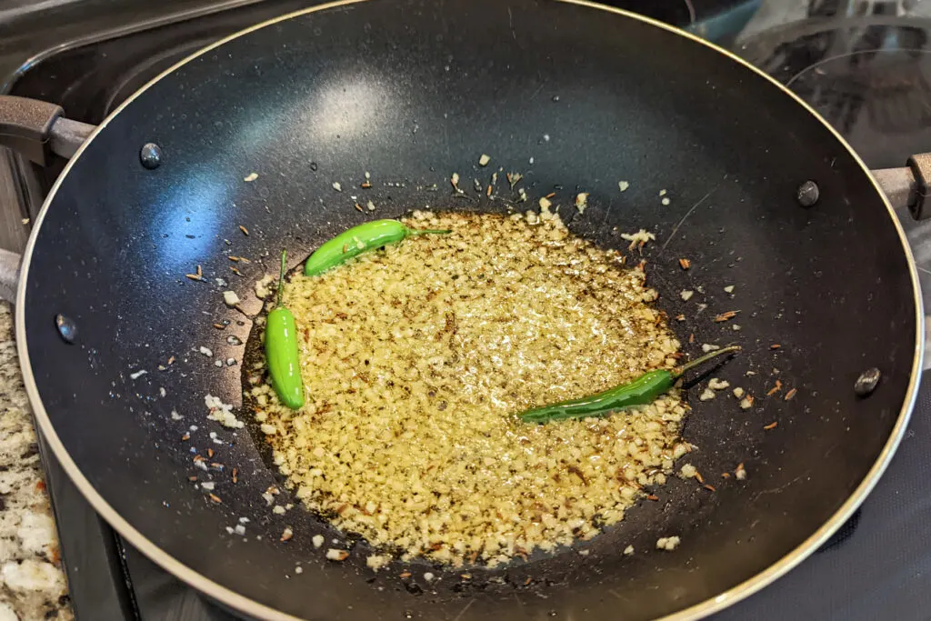 Garlic and ginger frying in a pan.