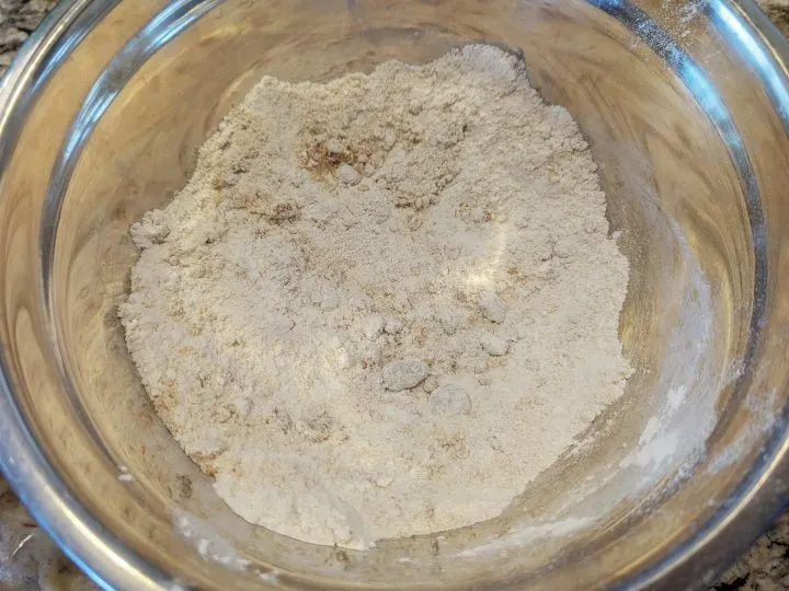 Dry ingredients in a mixing bowl for banana bread.