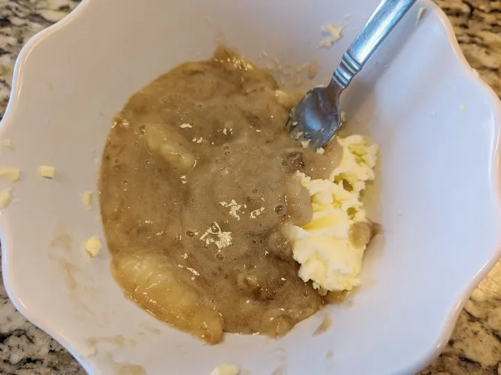 mushed banana and butter in a bowl