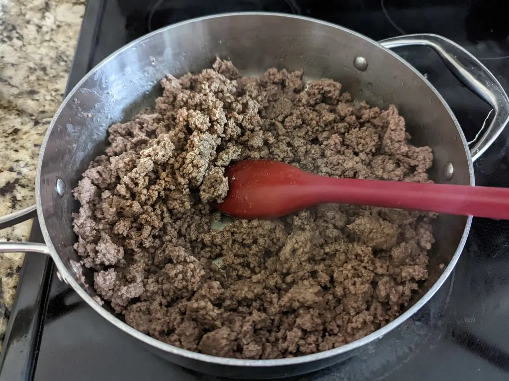 Ground beef browning in a saute pan.