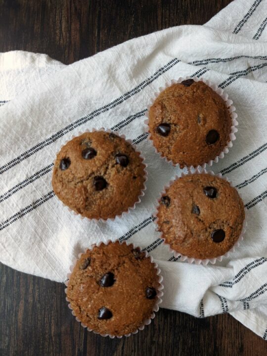 Chocolate protein muffins in held in a linen.