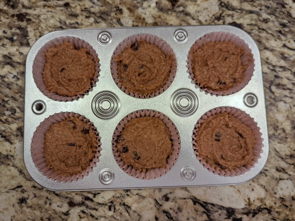 A muffin tin filled with batter.