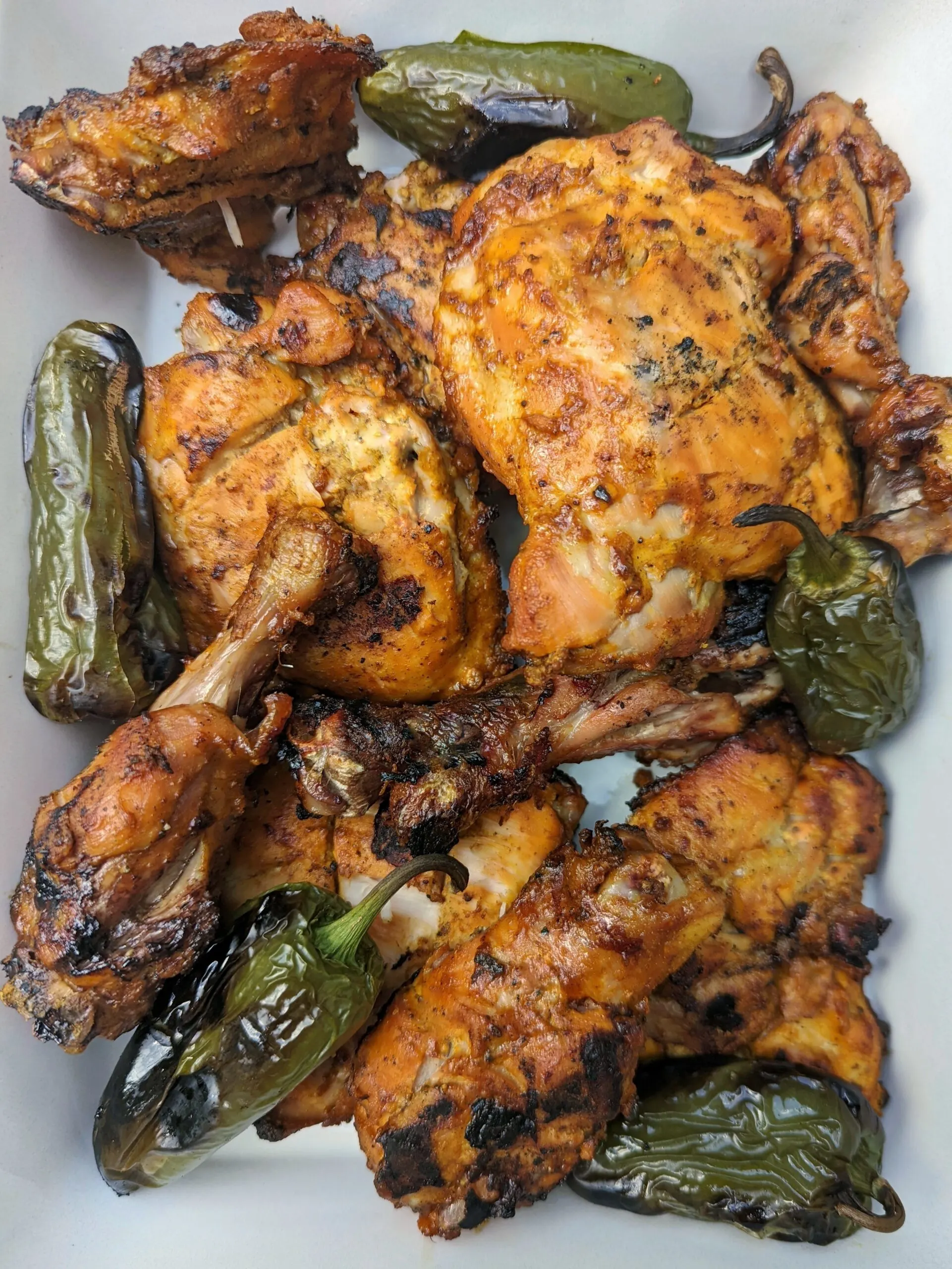 Grilled tandoori chicken with blistered chilies.