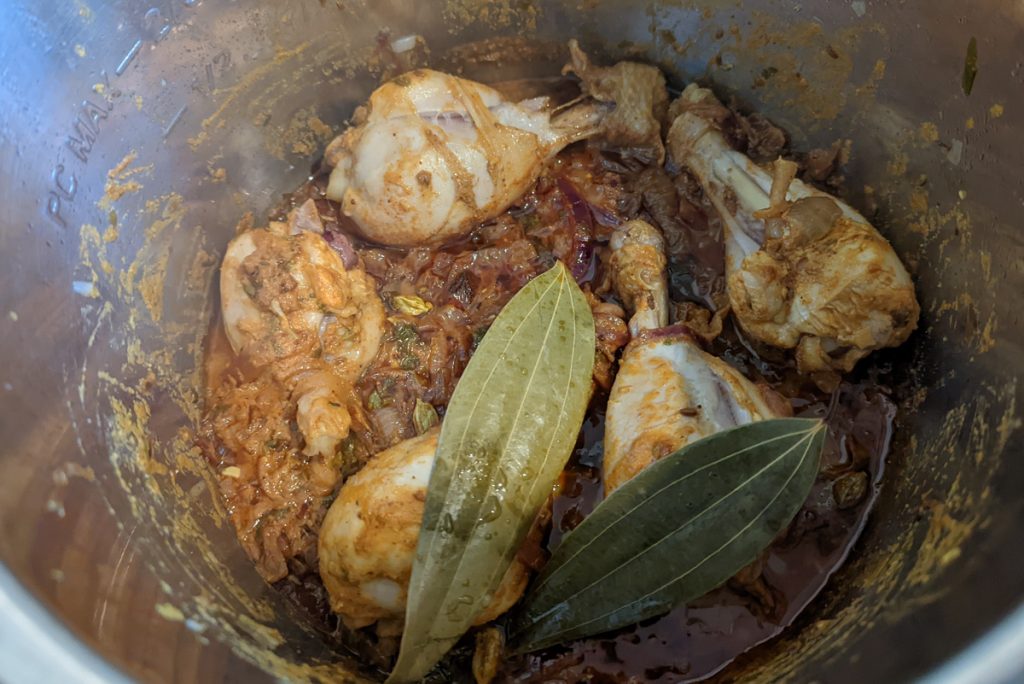 Add bay leaves to the chicken biryani to infuse flavor.