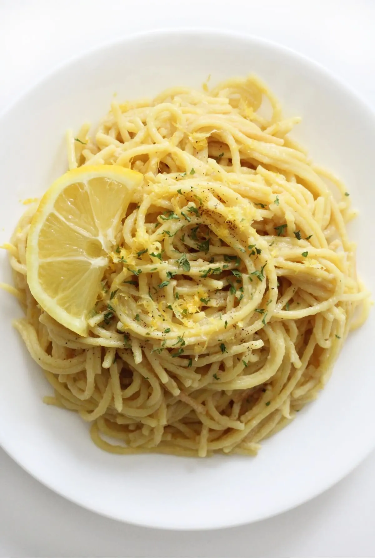 An upclose of the noodles topped with cheese and lemon wheels.