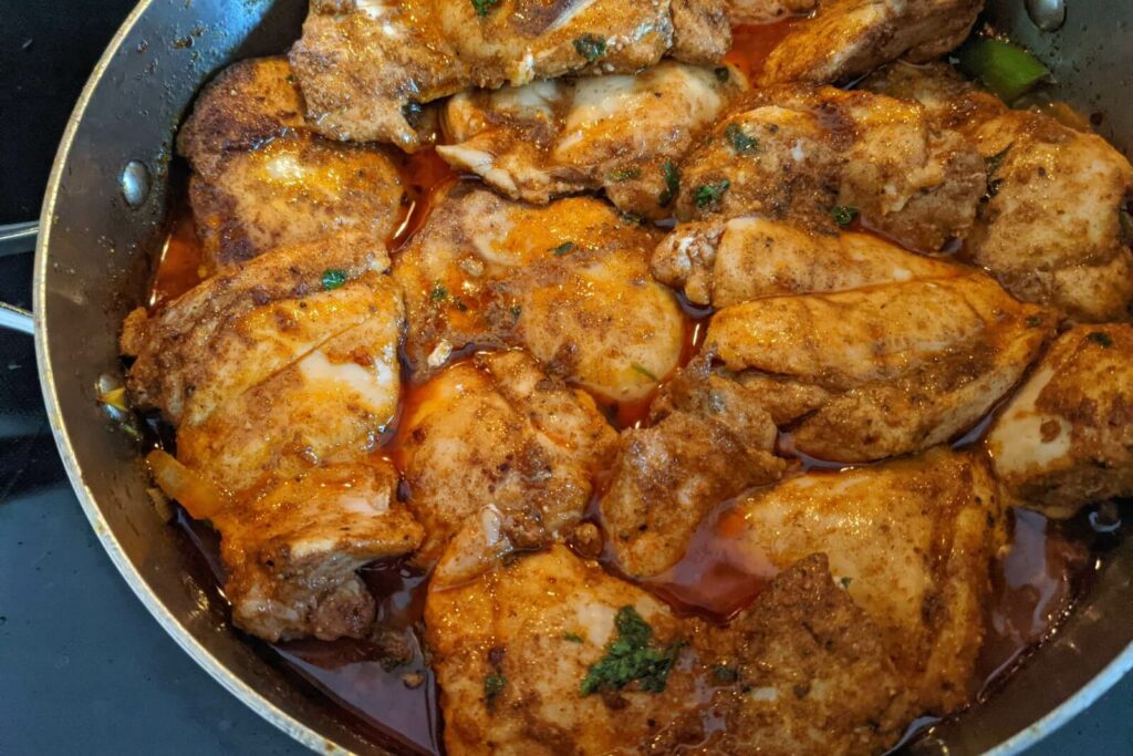 Chicken added back to the pan to stew.