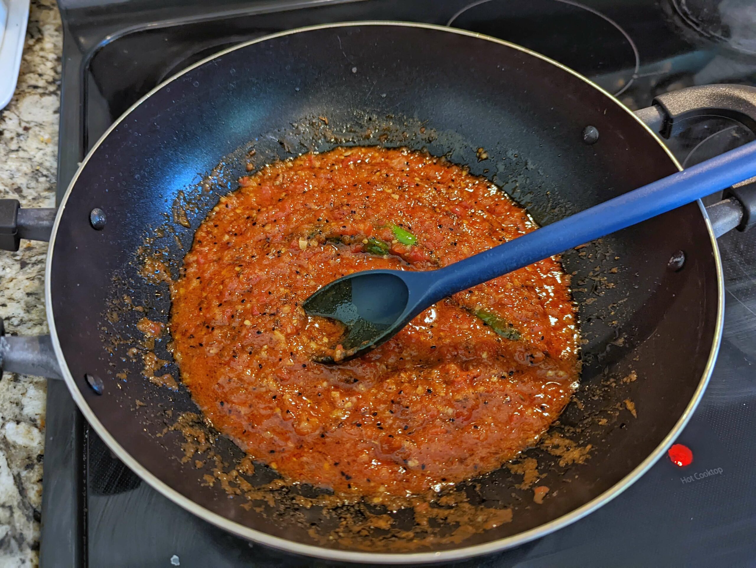 Add the spices and the tomatoes puree to the ginger and garlic mixture.