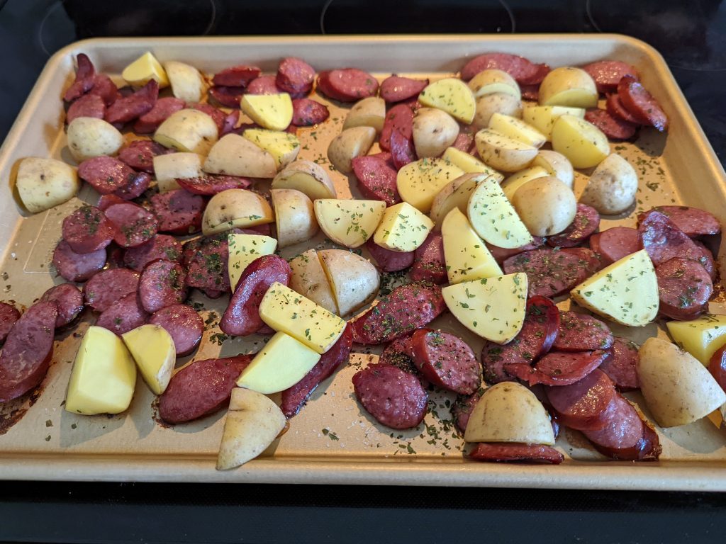 Remove the sheet pan after 15 minutes and move the kielbasa and potatoes around until full incorporated.