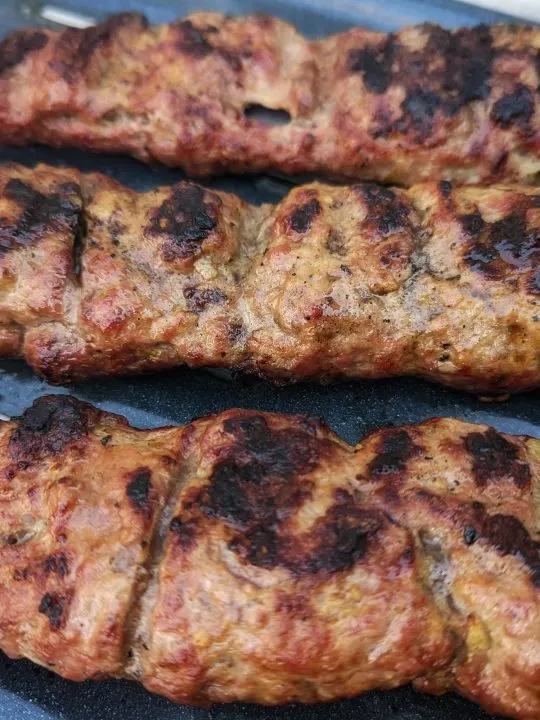 Fresh kabob koobideh off of the grill is ready to be served.