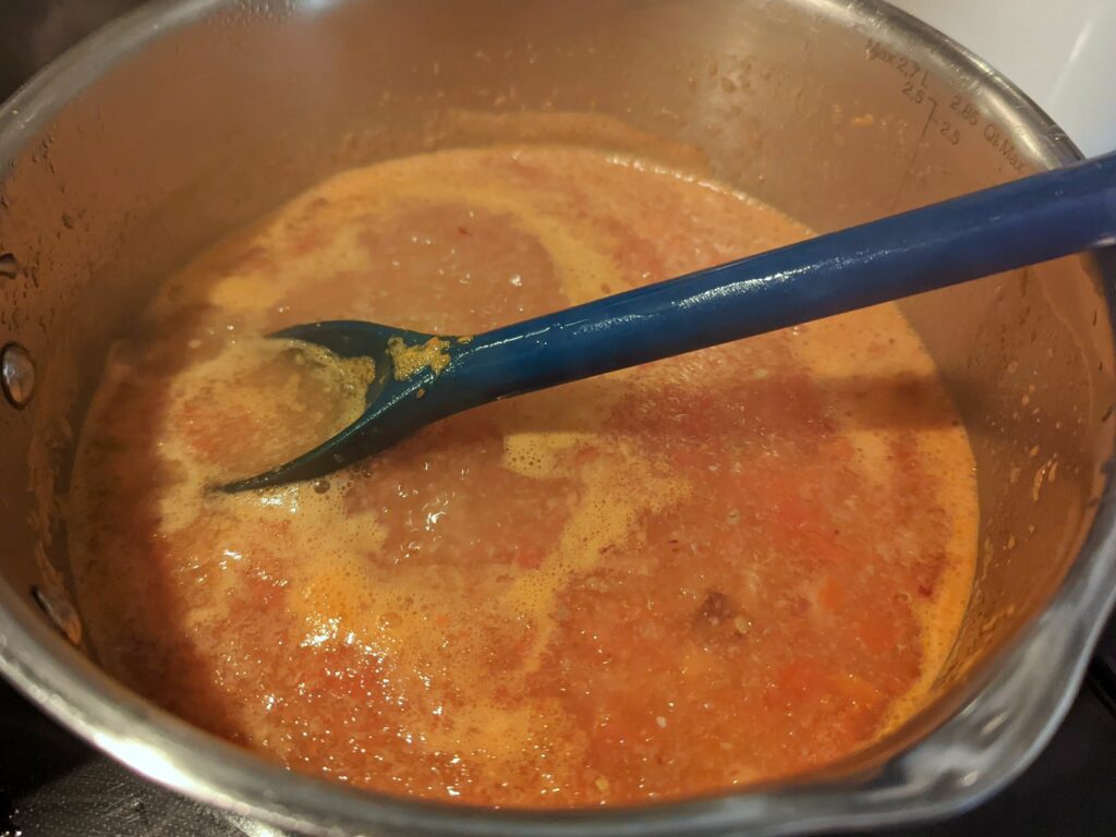 Simmer the tomato mixture.