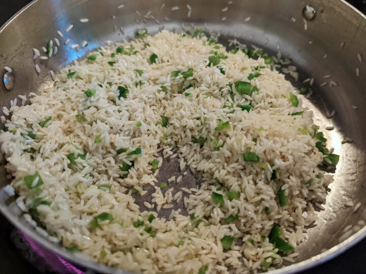 Add garlic and jalapeño to the toasted rice; cook until softened.