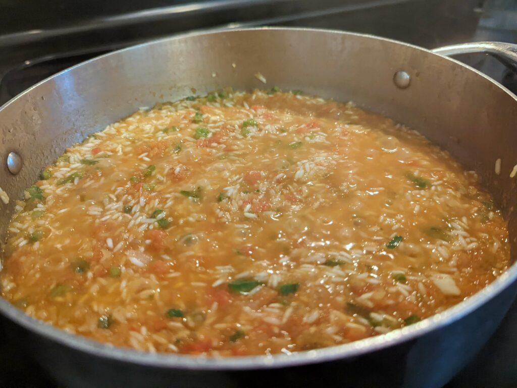 Hot tomato mixture over the rice and cook.