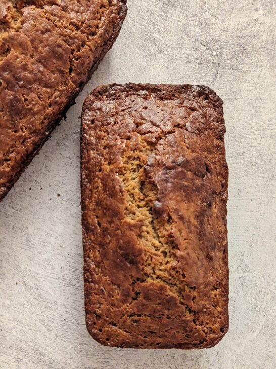 Two loaves of banana bread on a table.