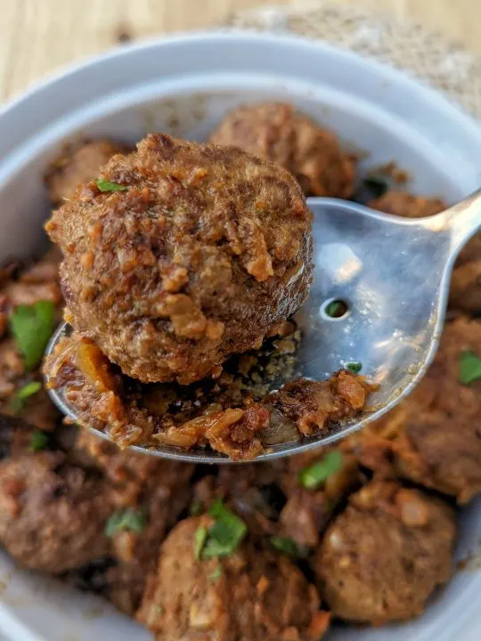 Moroccan meatballs are ready to serve in a serving bowl.