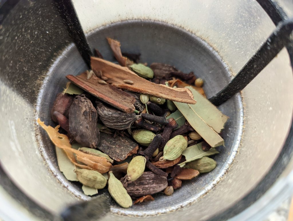 Grind the whole toasted spices in batches.