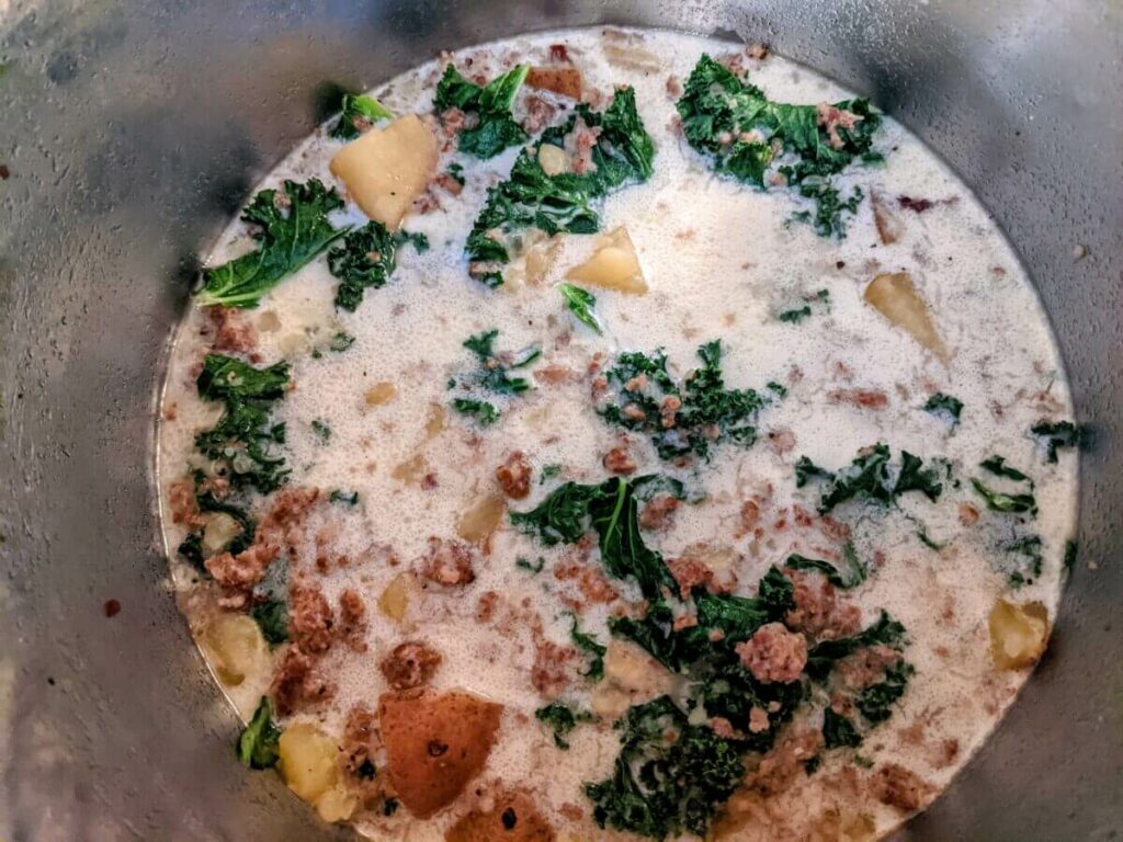 Add the cream and kale.
