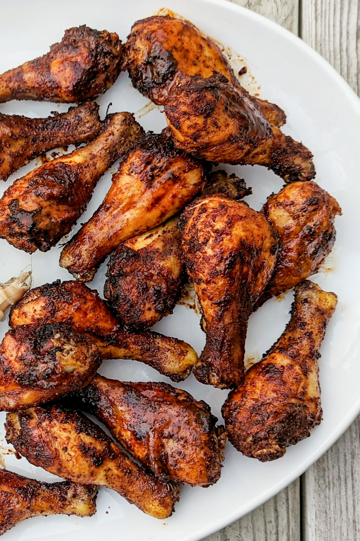 BBQ Baked Chicken Legs on a platter with corn.