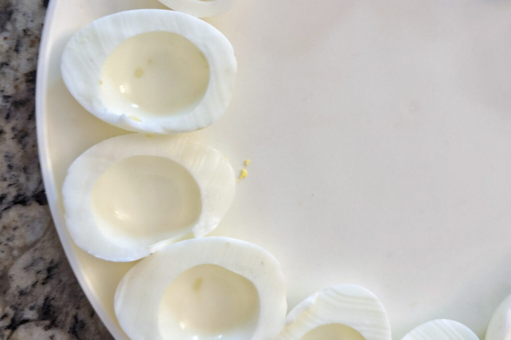 Egg whites hollowed out on a plate. 