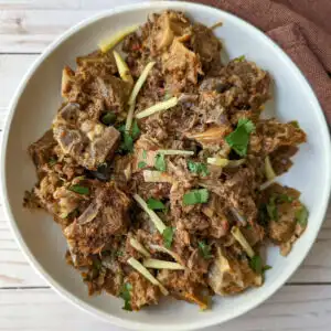 Bhuna gosht on a plate with garnish.