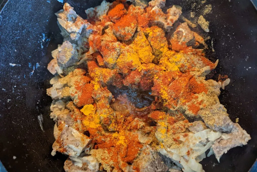 Ground spices added to the cooking bhuna gosht. 