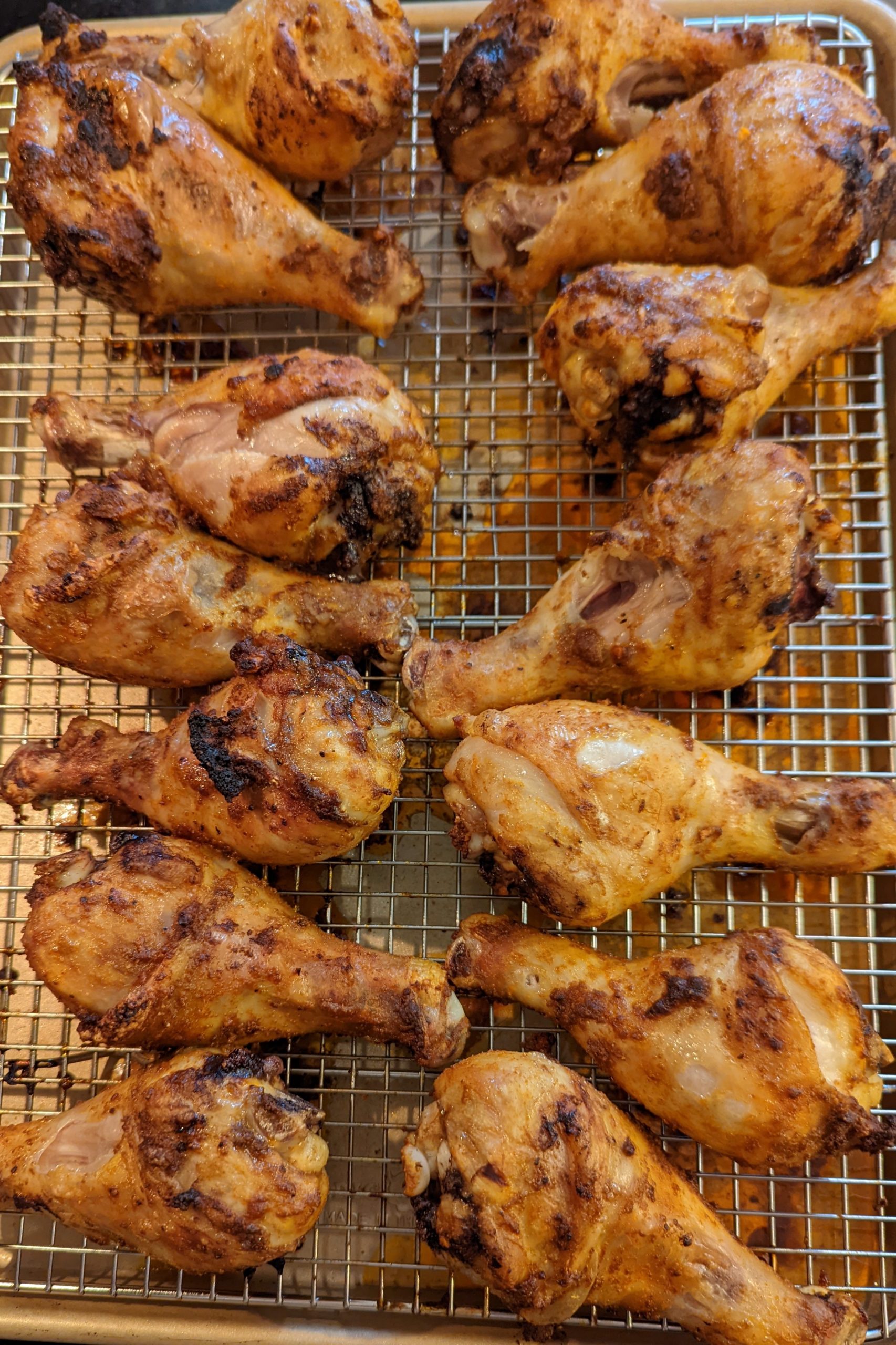 Peruvian Chicken Drumsticks resting on a wire rack and ready to be served.