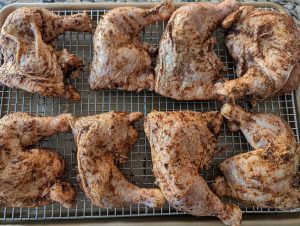 Line the chicken onto a sheet pan to begin roasting.