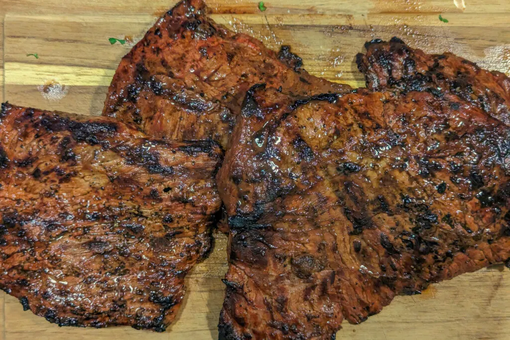 Steak resting on a cutting board.