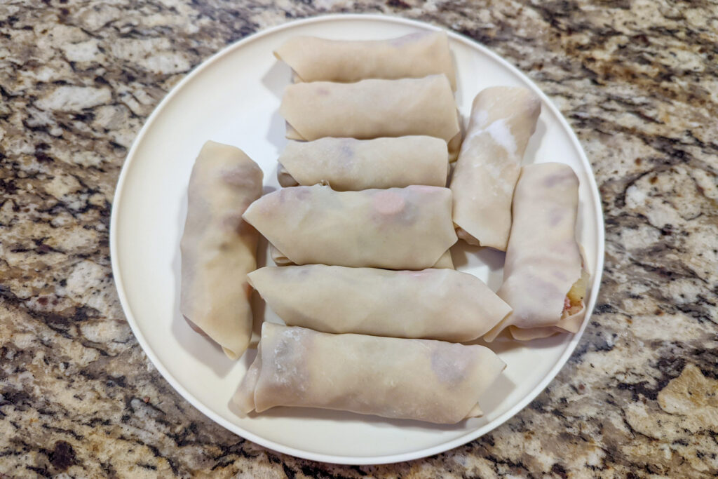 Egg rolls wrapped on a plate.